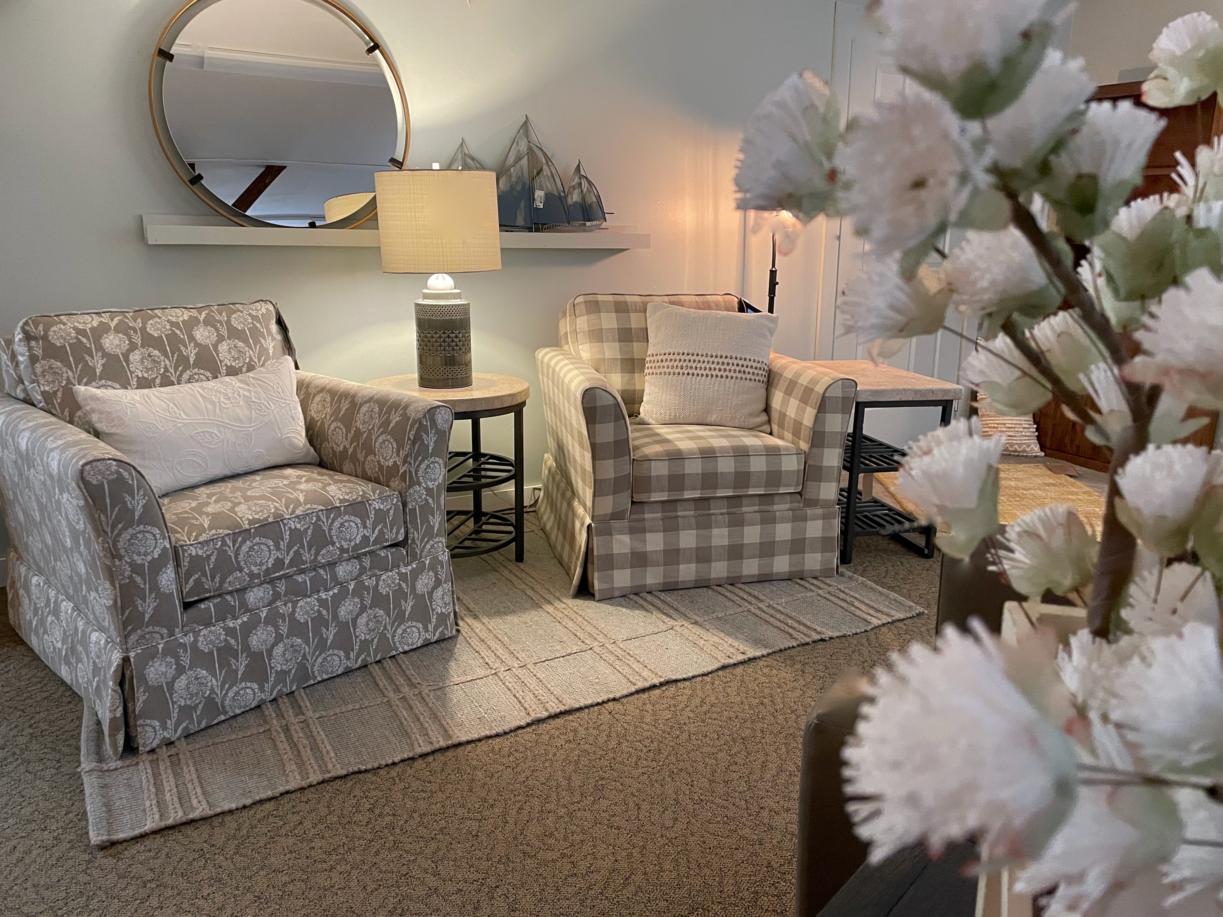 Perry's Home Furnishings & Design showroom featuring two swivel chairs, one with a pattern and one in plaid