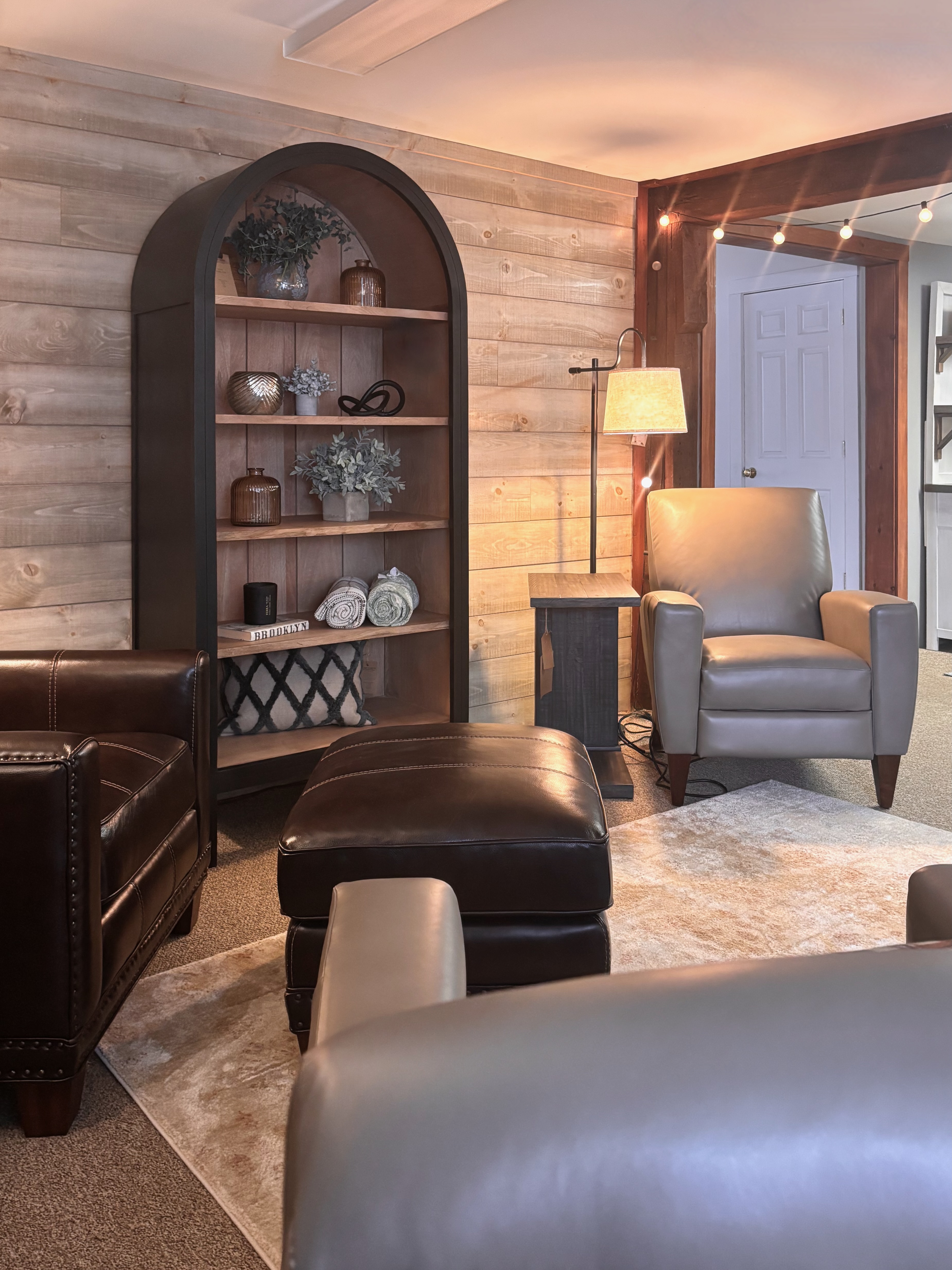 Perry's Home Furnishings & Design showroom with a bookshelf and leather chairs