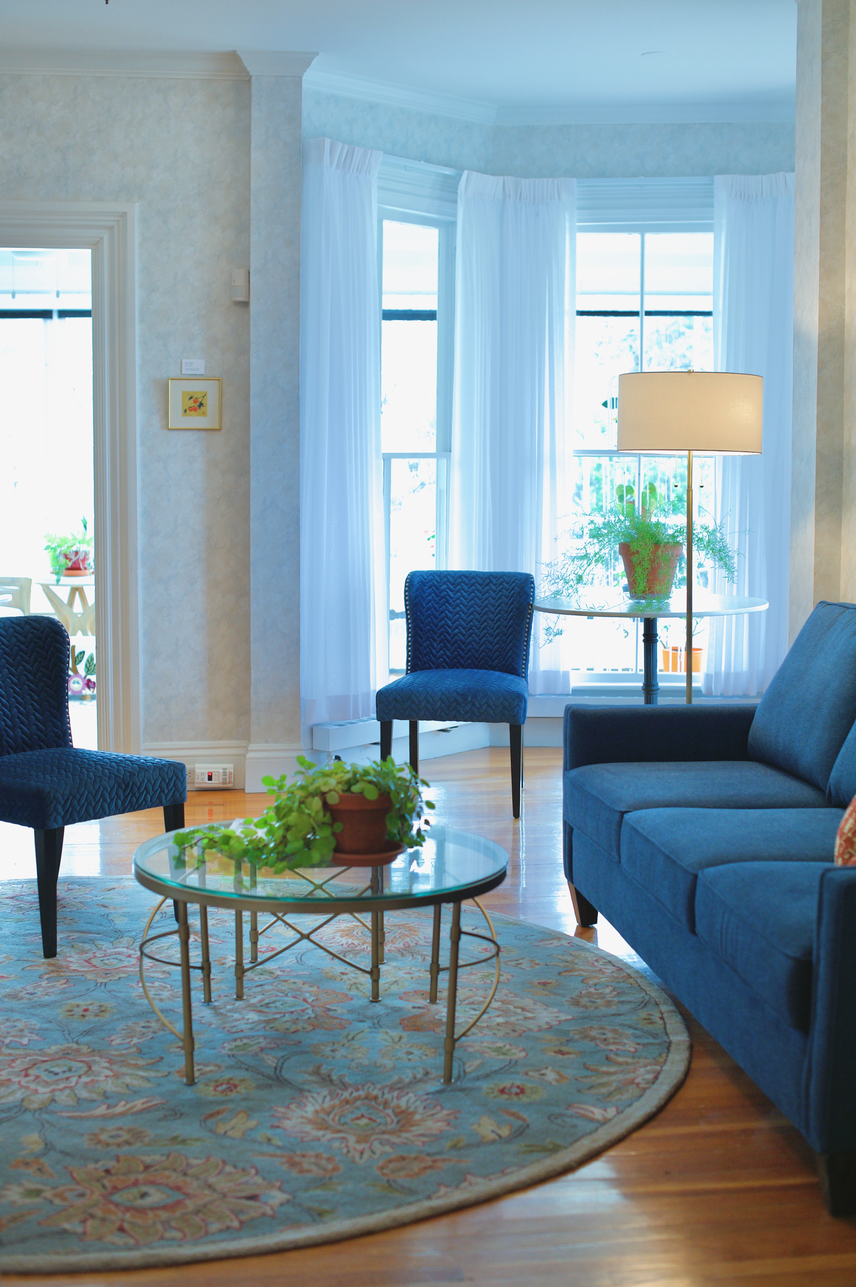 Blue sofa and two accent chairs at the president's house at the University of Maine Orono campus.