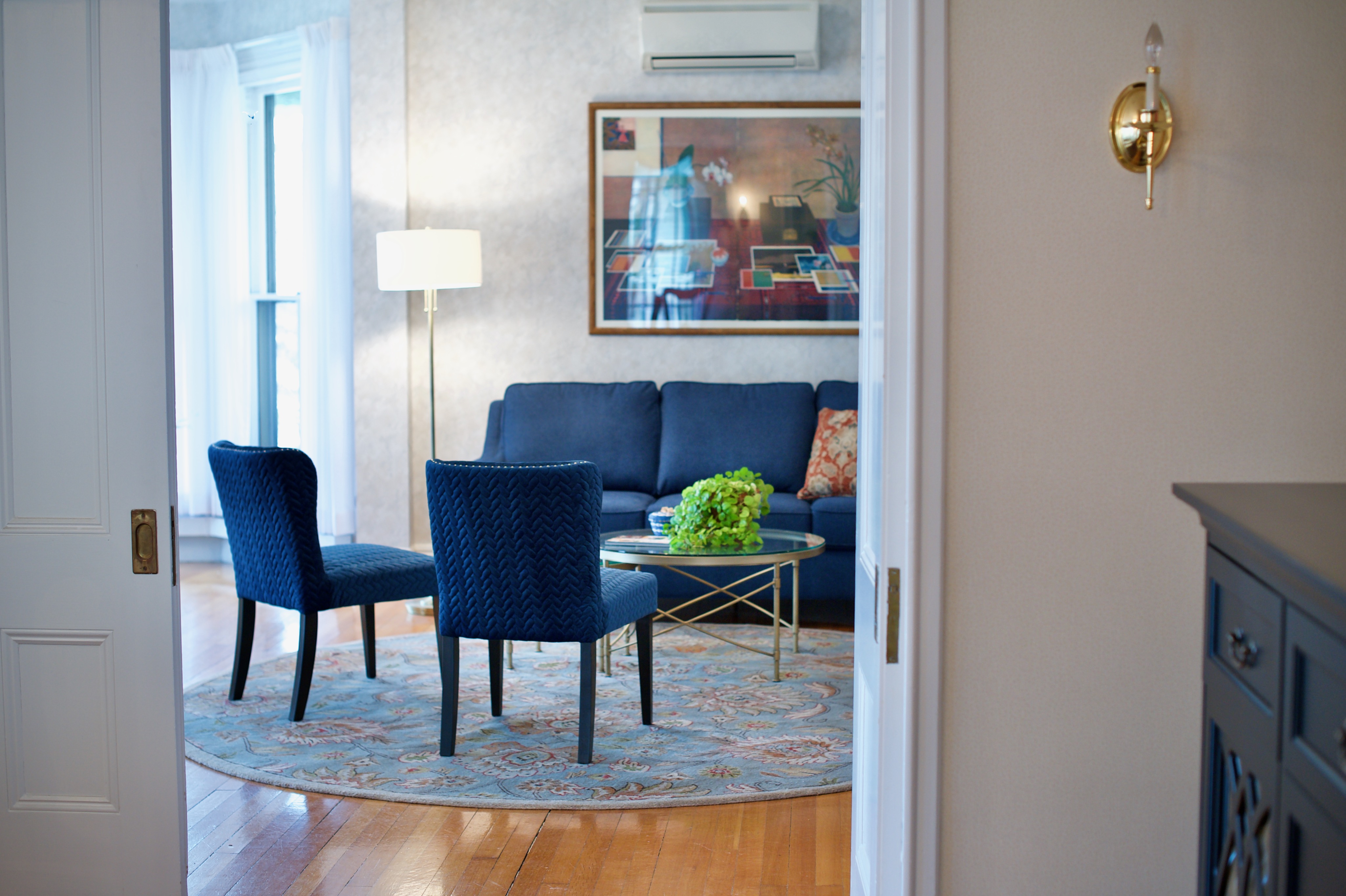 Blue sofa and accent chairs from another angle at the president's house at the University of Maine Orono campus.