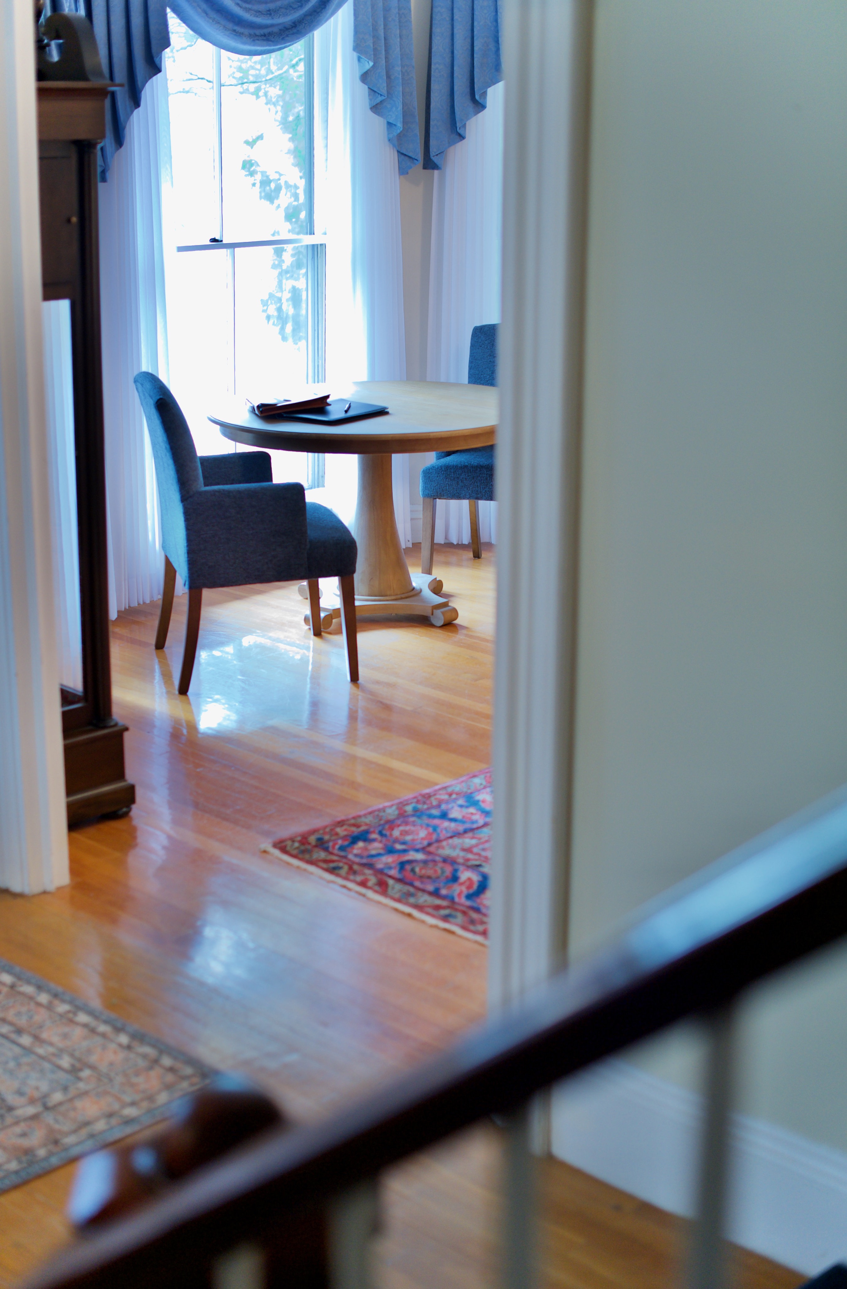 Blue chairs at a round table at the president's house at the University of Maine Orono campus.