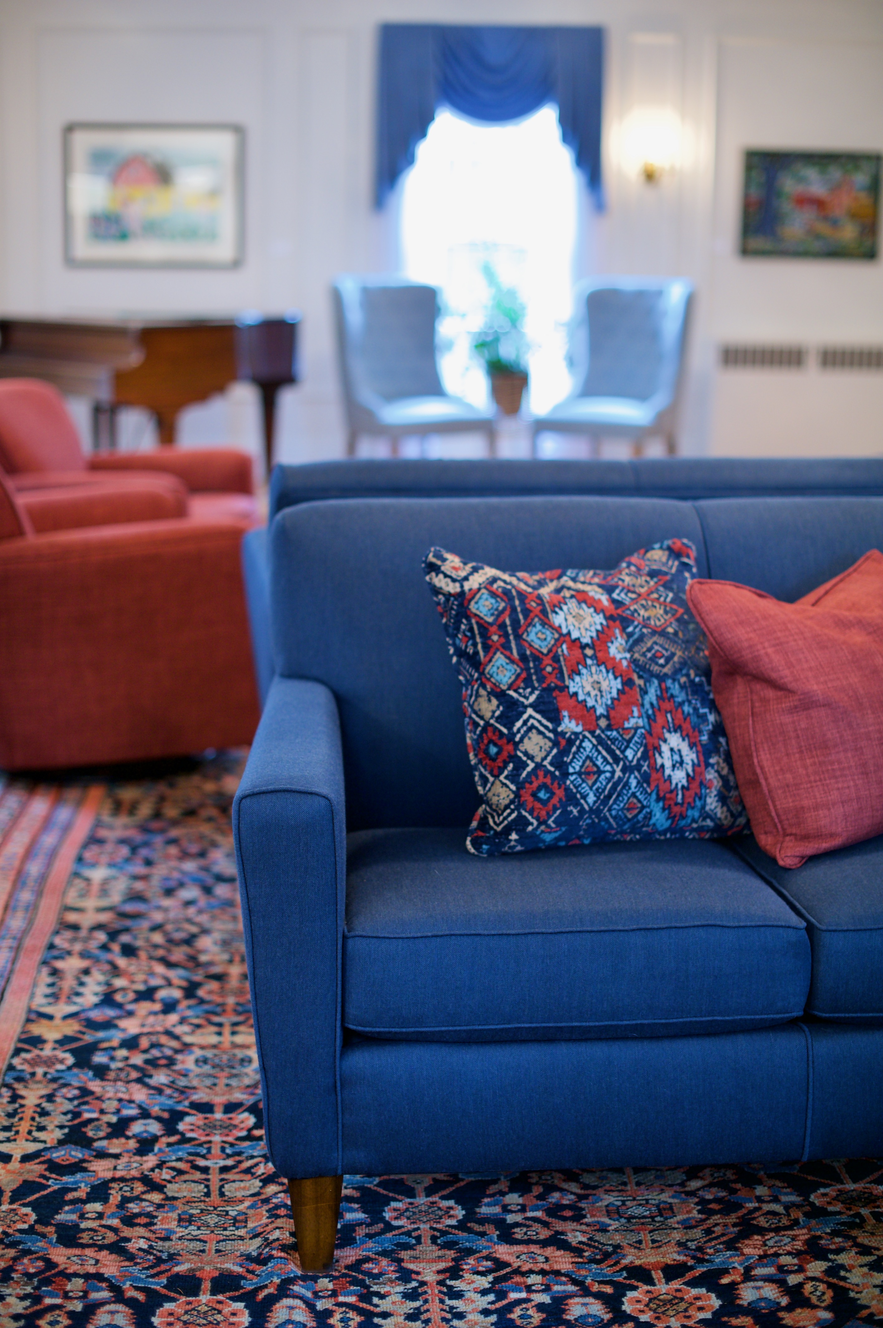 Red and blue patterned pillows at the University of Maine Orono campus designed by Perry's Home Furnishings & Design.